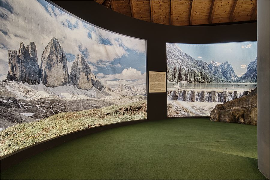 The Three Peaks panorama in the exhibition room of Cheese World, with old equipment in front